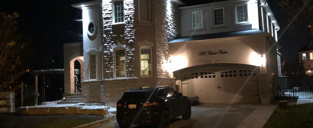Exterior lighting on a stone home at night