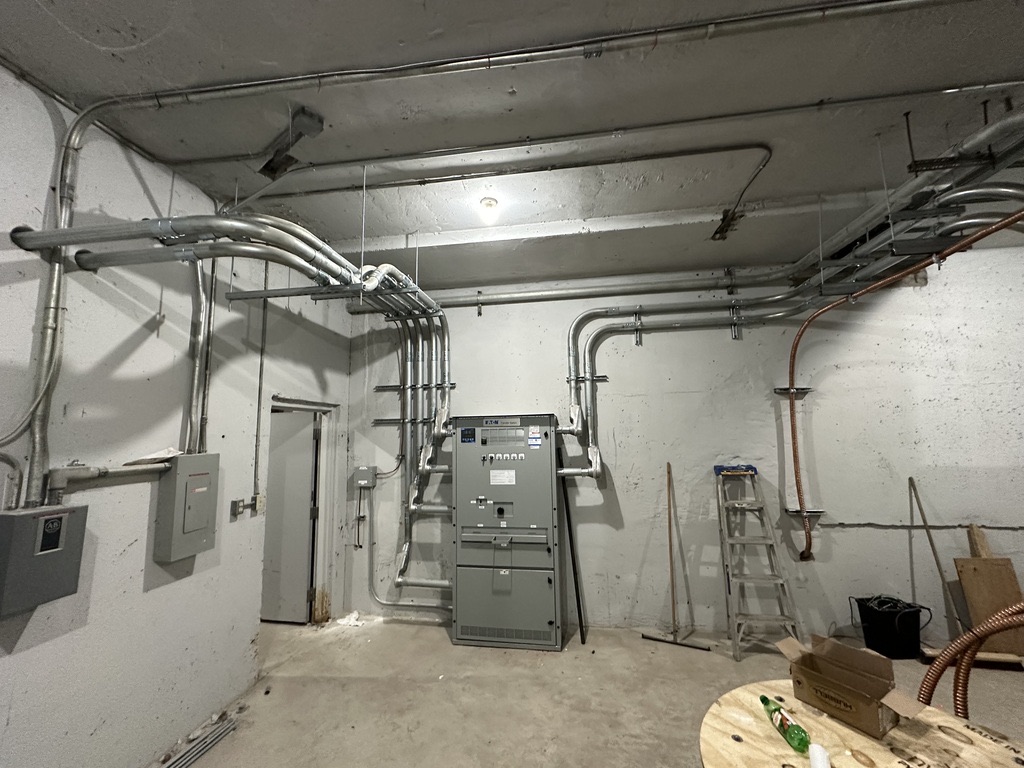 Commercial electrical room with conduit runs and switchgear
